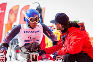 US Coach Kevin Jardine discusses strategy with US downhill racer Tyler Walker before his run