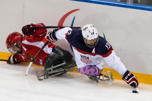 photo by Ken King Wounded Warrior Project veteran, Joshua Sweeney, takes the puck from Russia in the gold medal game during the 2014 Winter Paralympics in Sochi.