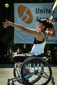photo by Michael A. Clubine Dana Mathewson reaches to serve the ball at the 14th Annual Jana Hunsaker Memorial Wheelchair Tennis Tournament
