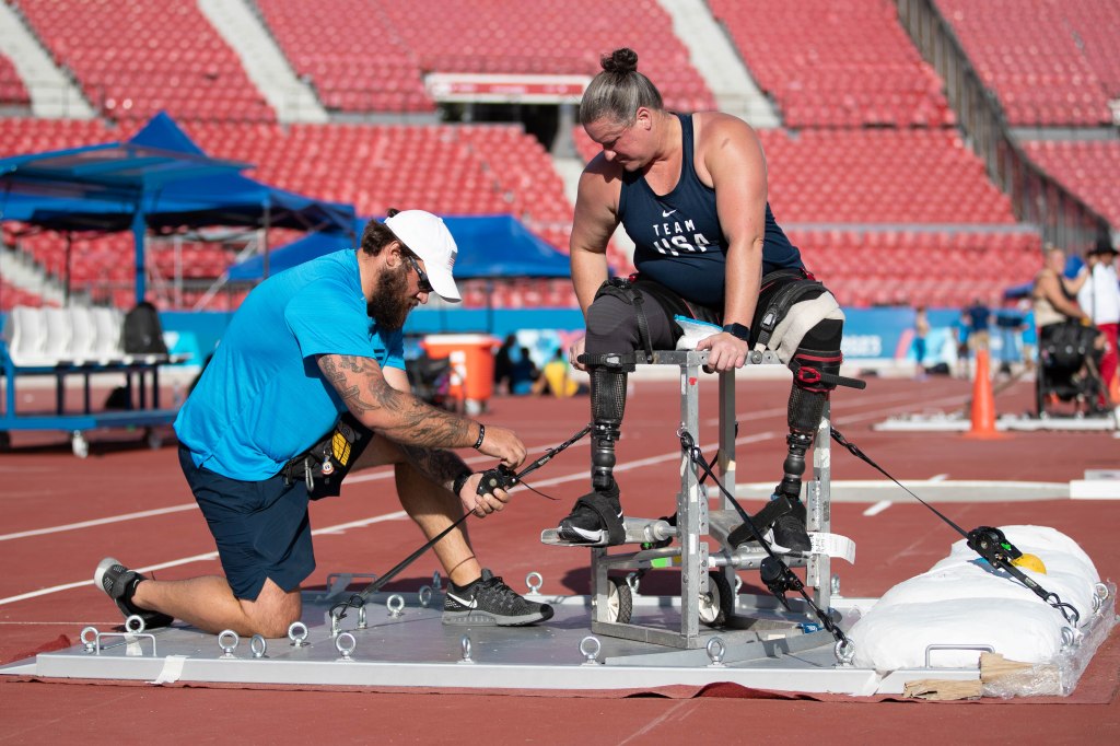 Christy Gardner receives help during one of her shot put practice sessions at the 2023 Parapan American Games in Santiago, Chile. 