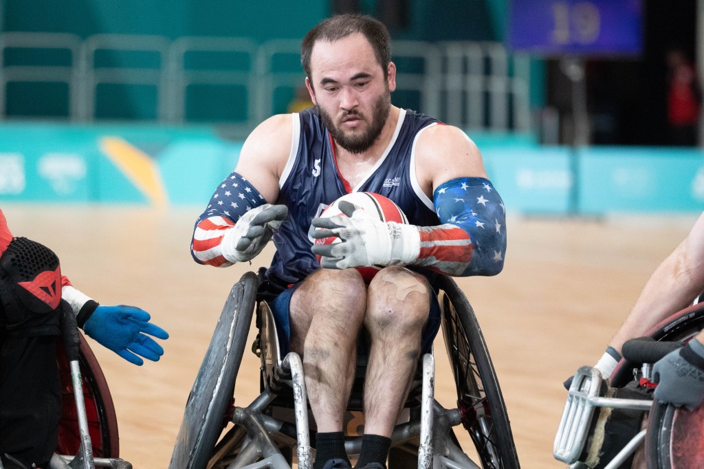 Charles Aoki squeezes past two Canadian defenders. He finished with a team-high 28 tries to lead Team USA to a 57-51 win over Canada in Thursday's gold medal game.