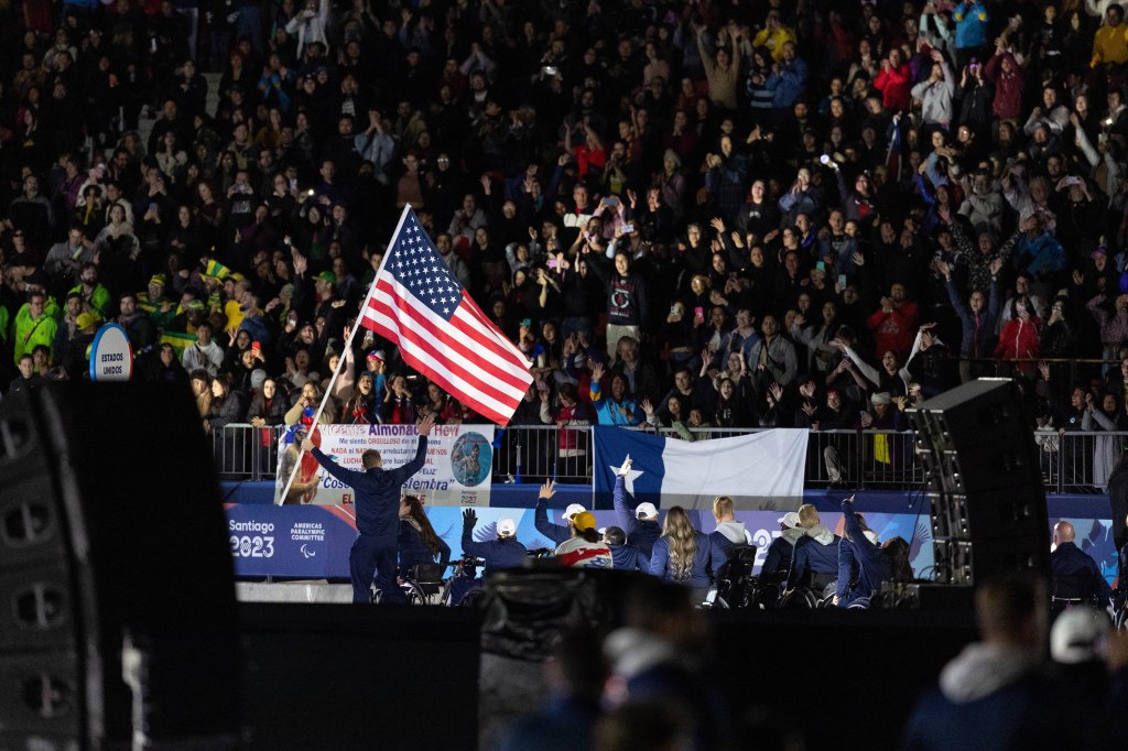 Team USA marches around the outside track of Estadio Nacional, being greeted with applause from the Chilean crowd.