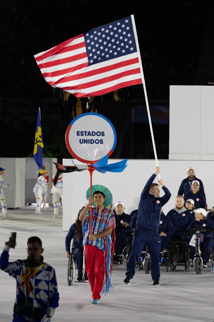 Para-Judoka Ben Goodrich carries the flag for Team USA as it marches through the parade of athletes in the opening ceremony.